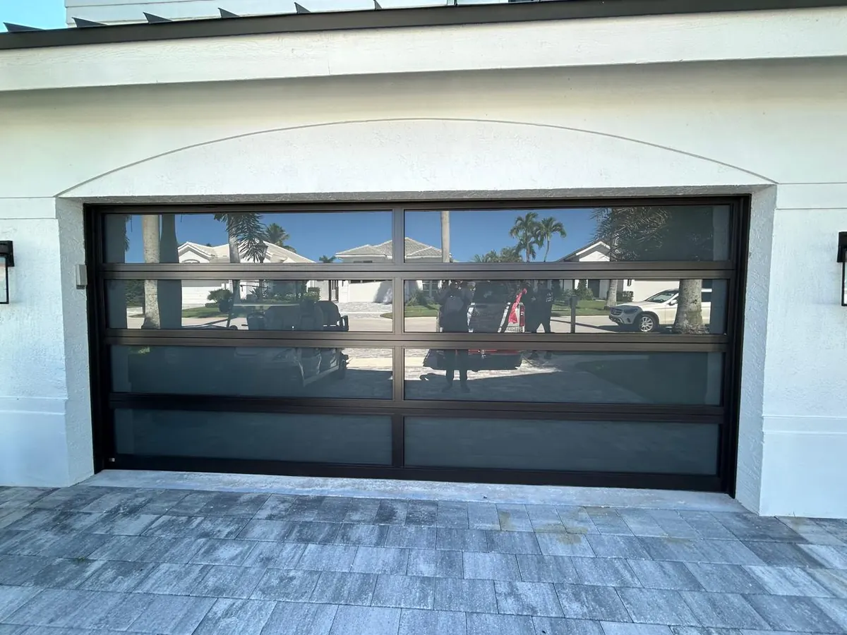 AA Impact full view glass door under an arched opening on a white stucco home