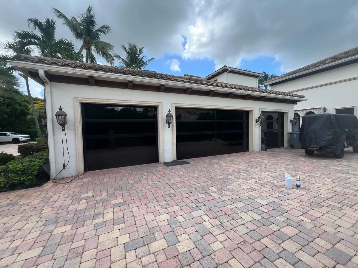 Two AA Impact glass doors on a Florida home with a tile roof and palms