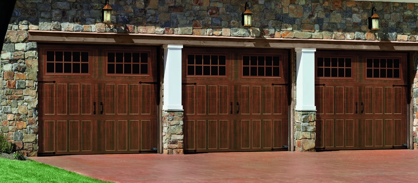 Amarr Classica carriage house doors in a dark walnut finish on a three-bay garage