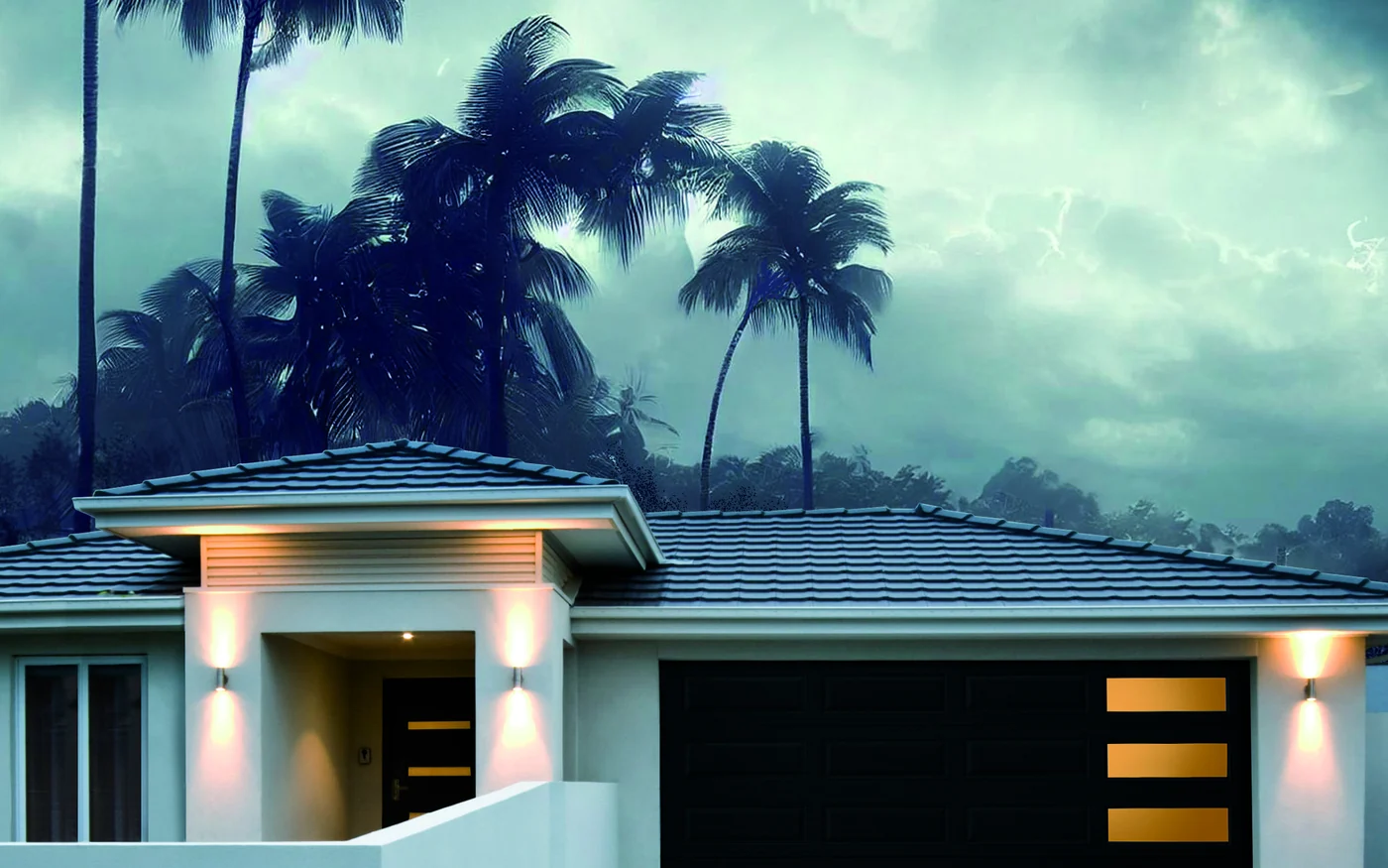 A modern flush Amarr garage door on a South Florida home under a storm sky