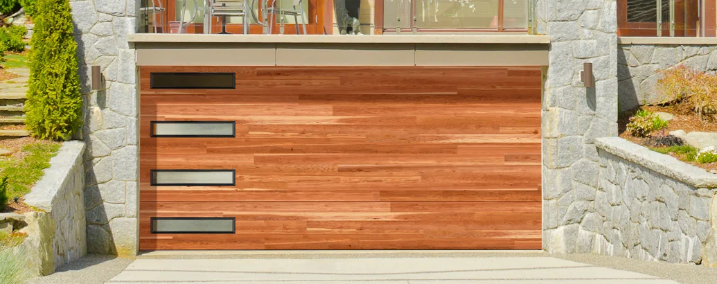 A modern horizontal wood slat garage door with narrow tinted glass strips