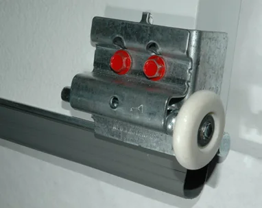A nylon roller and hinge seated in a garage door track