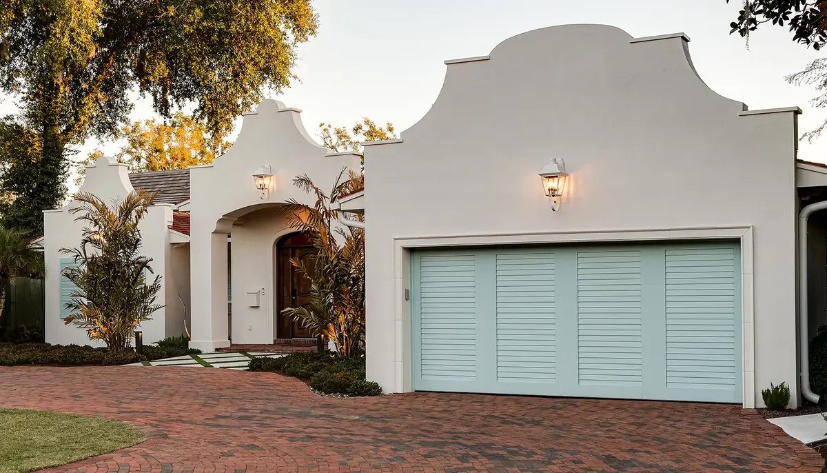 Clopay Canyon Ridge Louver door on a Spanish style stucco home with a paver drive