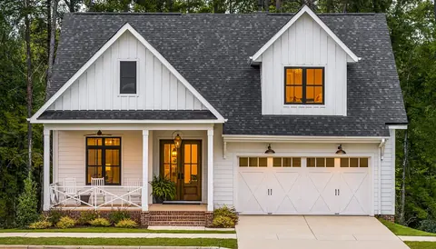 Black Clopay Coachman carriage house doors on a white two car garage