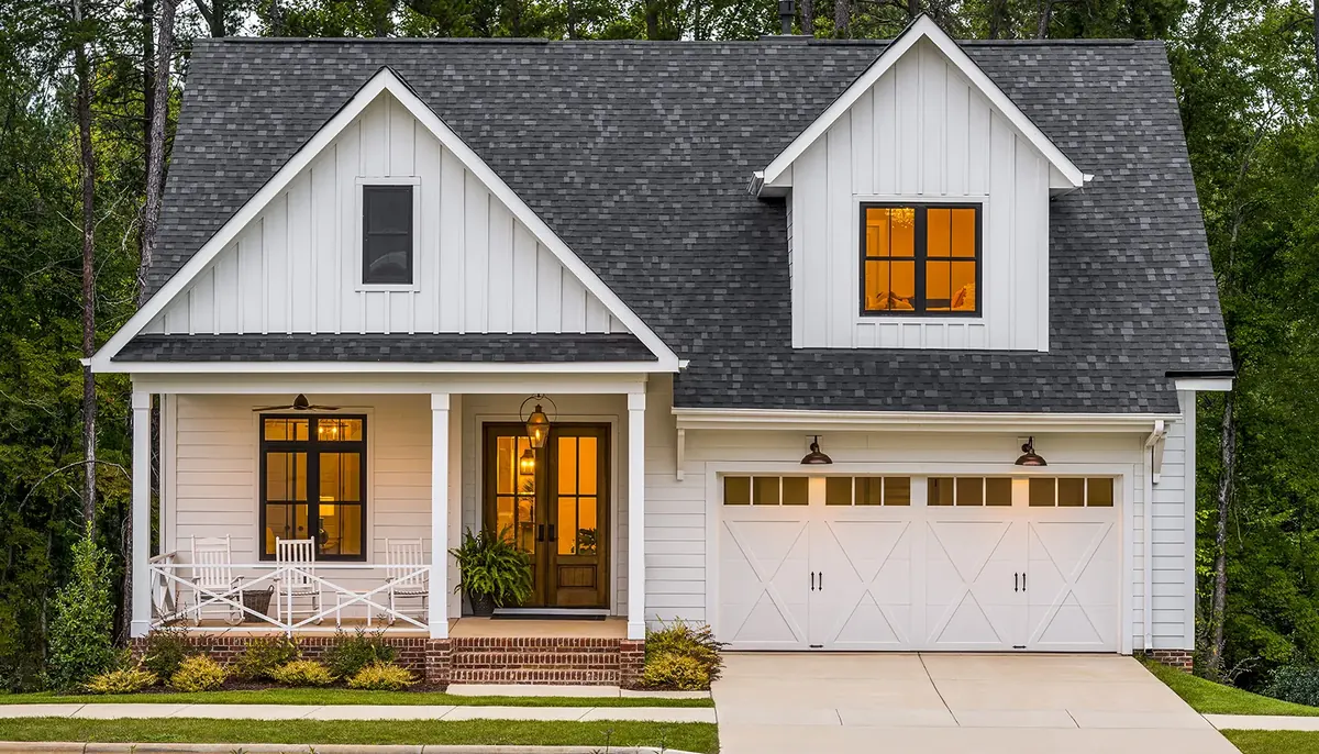 Black Clopay Coachman carriage house doors on a white two car garage