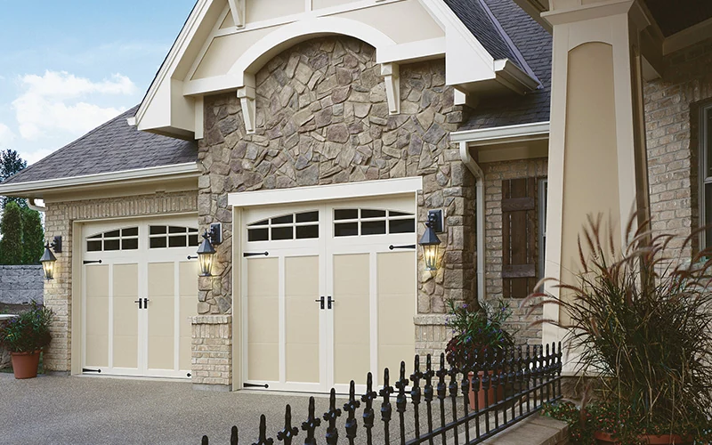Coachman carriage doors on a stone and stucco home with an arched entry