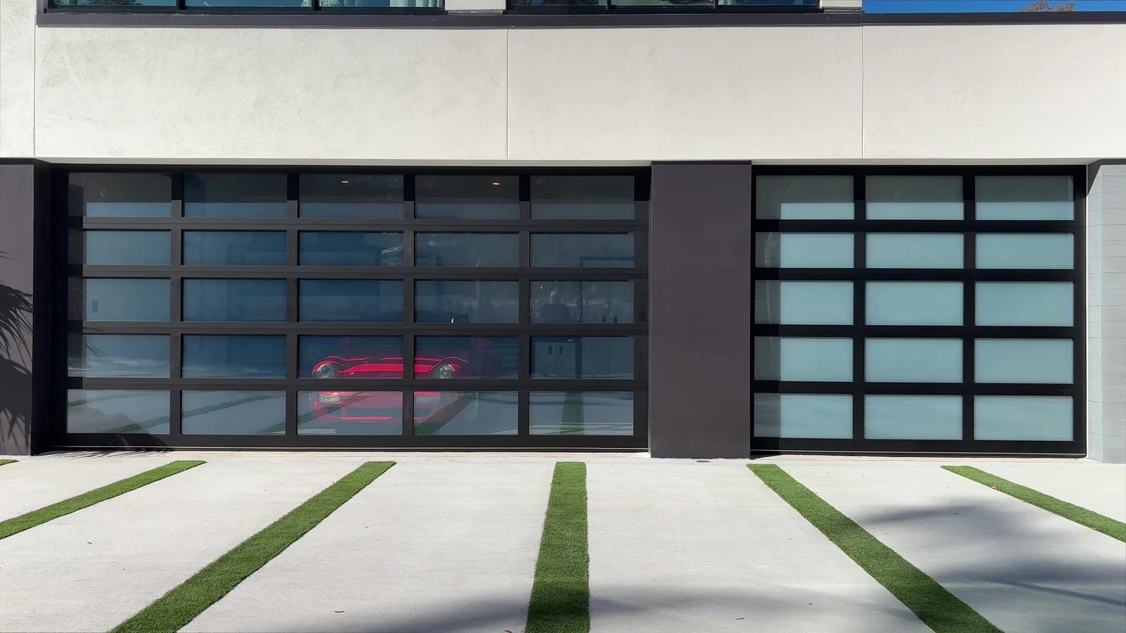 Two bays of frosted full view glass doors on a contemporary home