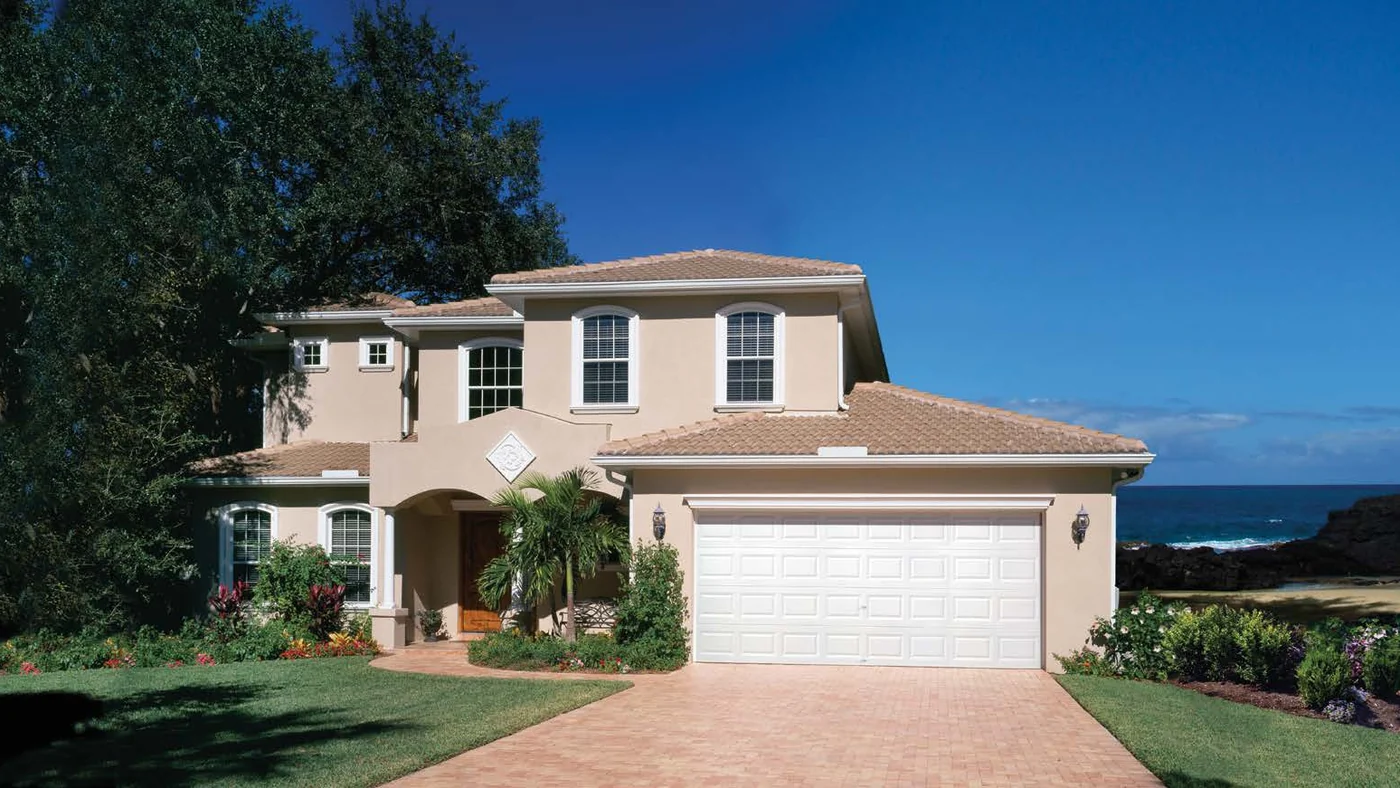 A Clopay short panel door in standard white on a Florida home with a barrel tile roof