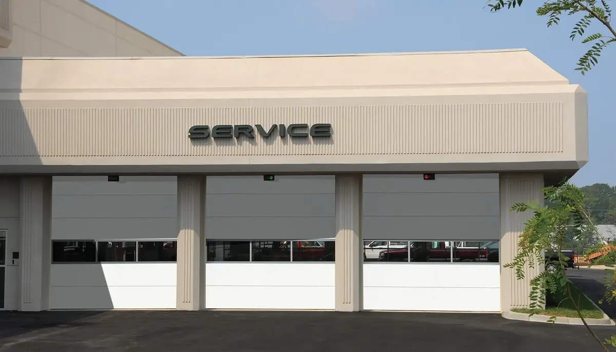 Clopay Energy Series Intellicore door, model 3722 flush doors with full width window sections on an auto service building