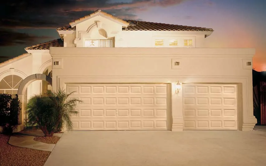 Clopay Value Series garage door, model 94 short traditional panel, a double and a single door on a stucco home