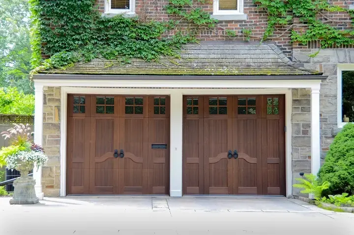 Raynor Revival Wood garage door, two stained wood carriage style doors with windows