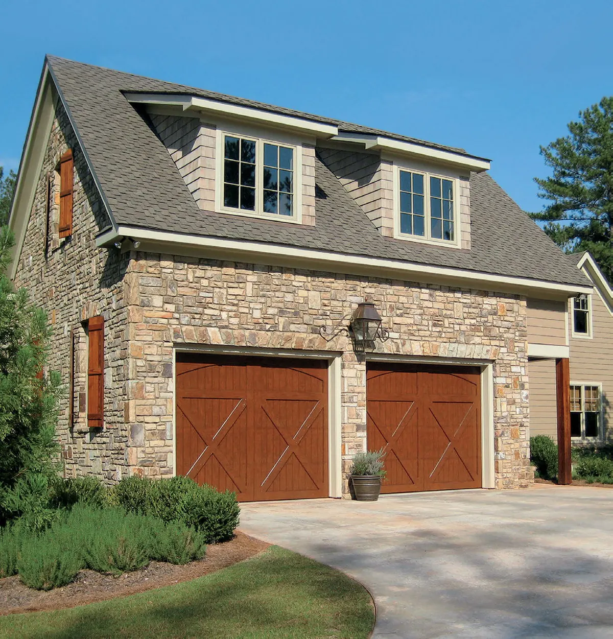 Eden Coast composite overlay carriage doors on a stone carriage house