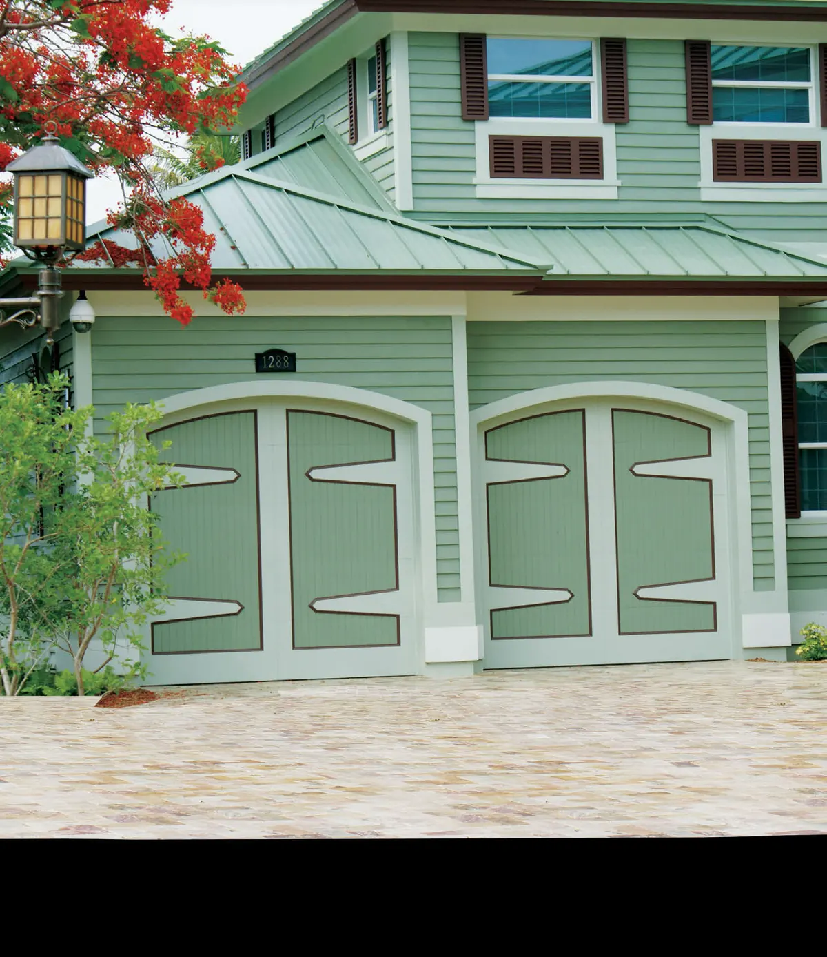 Green Eden Coast carriage overlay doors on a Key West style home