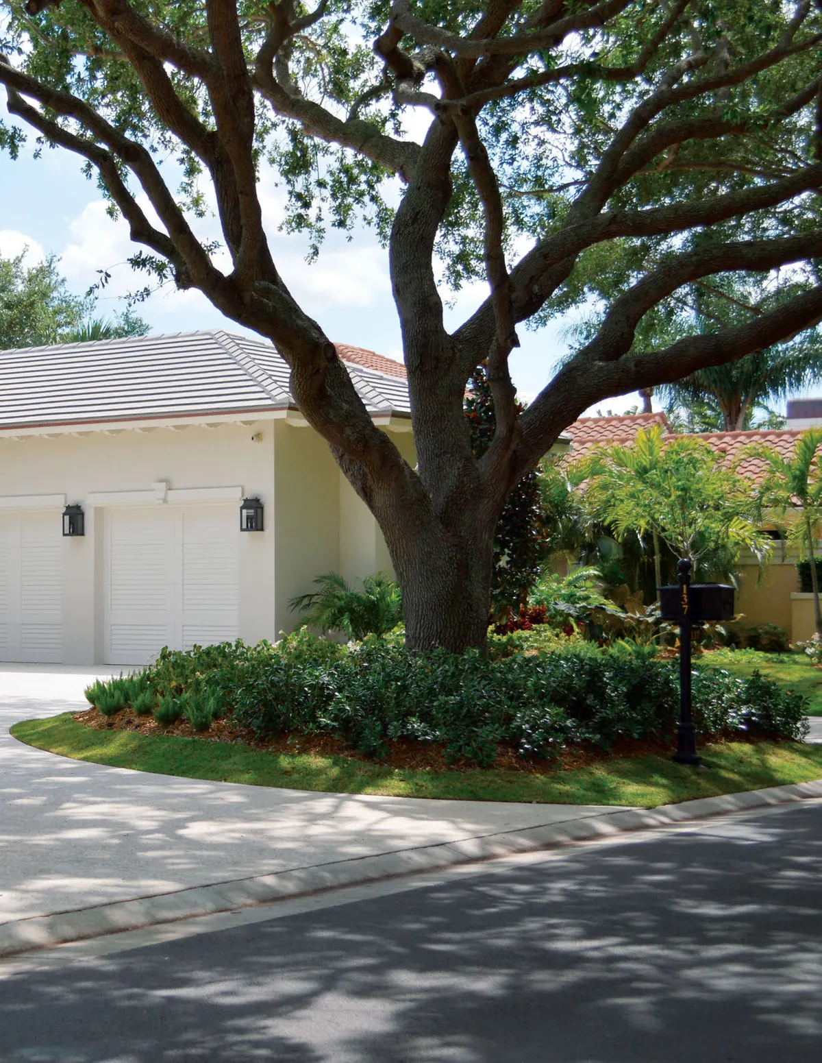 White Eden Coast steel sandwich doors on a Florida home under an oak