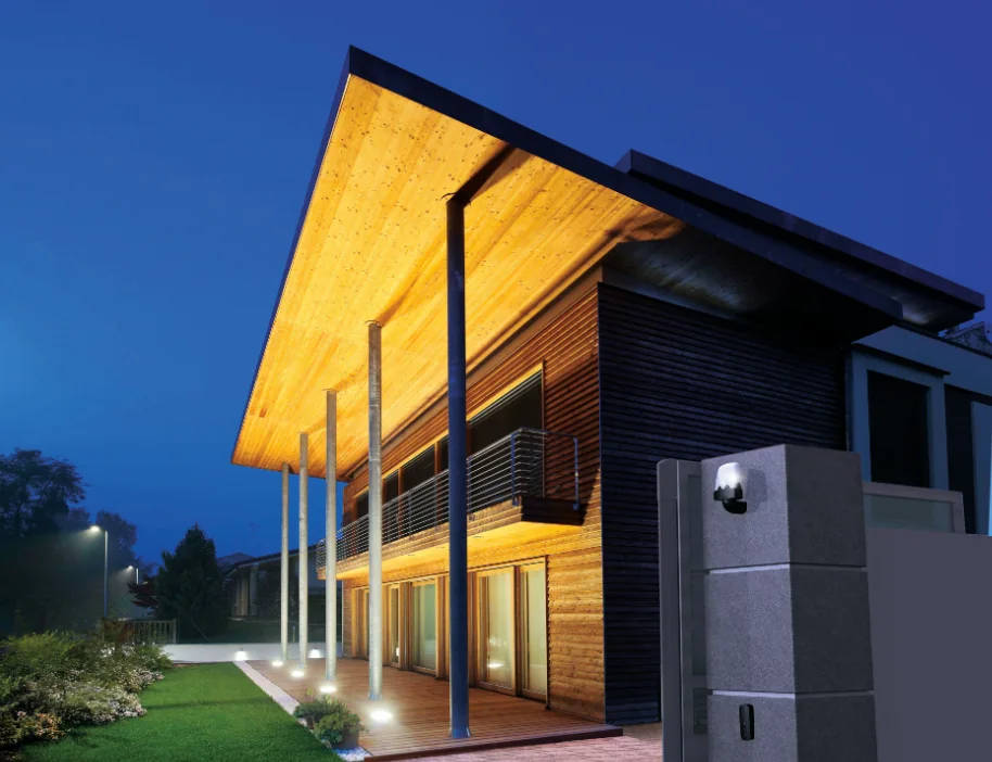 A modern home at dusk with an automated entrance