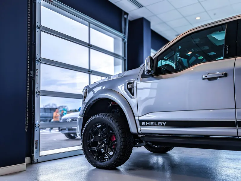 Full view aluminum and glass commercial door at a vehicle showroom