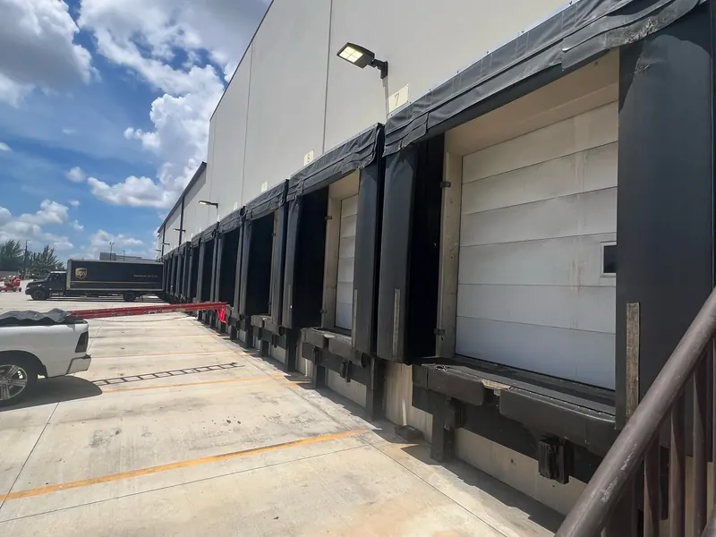 Loading dock exterior with dock seals and white doors