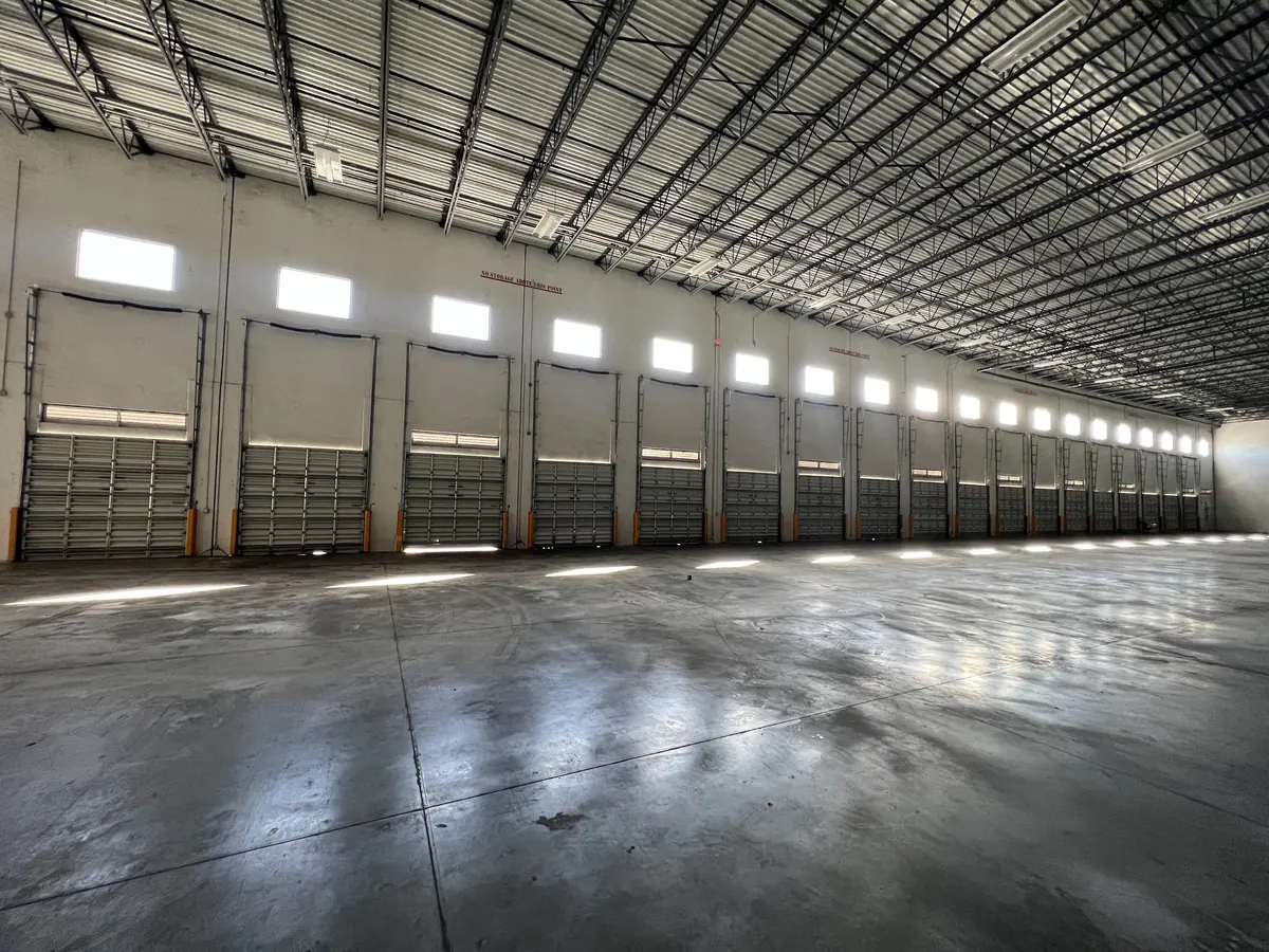 A long row of loading bay doors running the length of a distribution warehouse