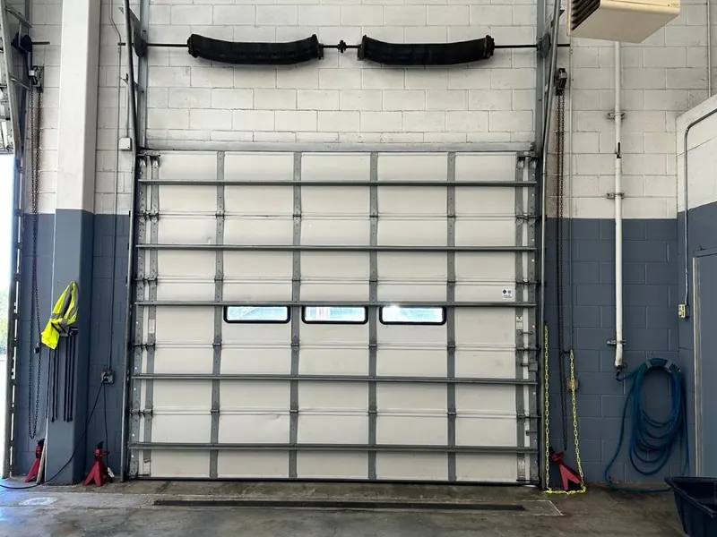 Arched full view glass bay doors on a fire station at night