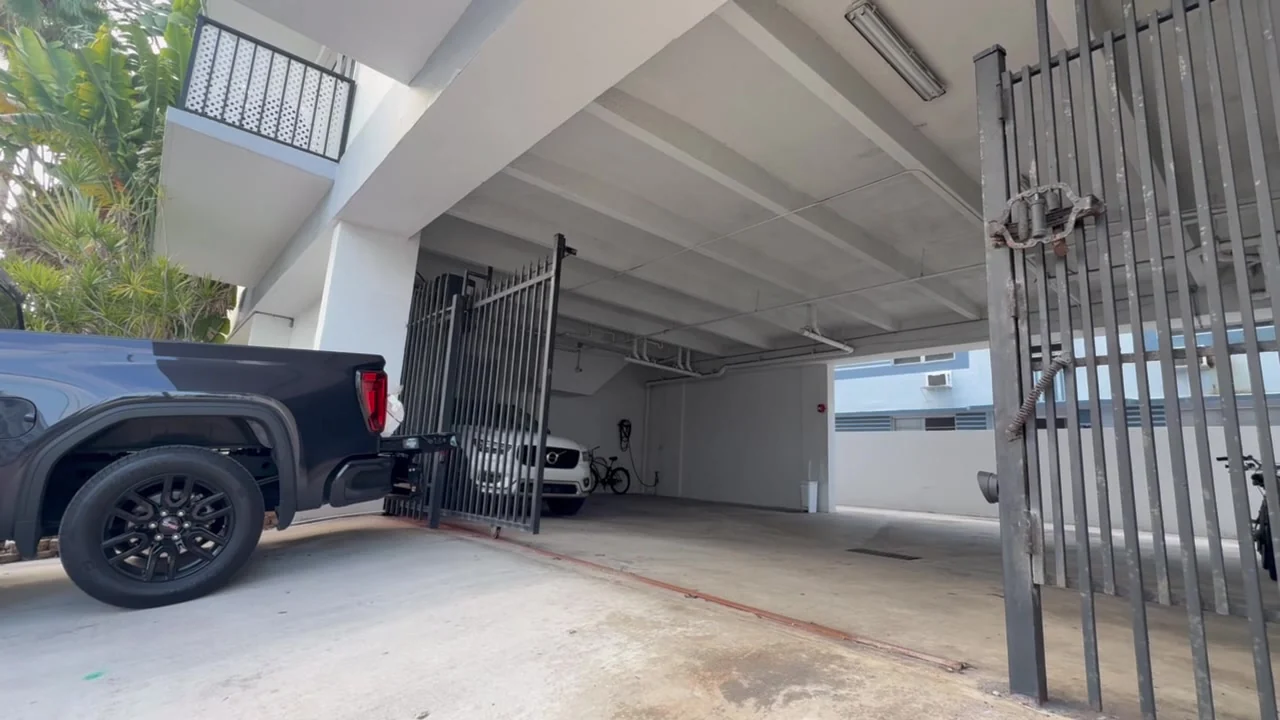 Ornamental driveway gates standing open beside a pickup at a CMC gate job