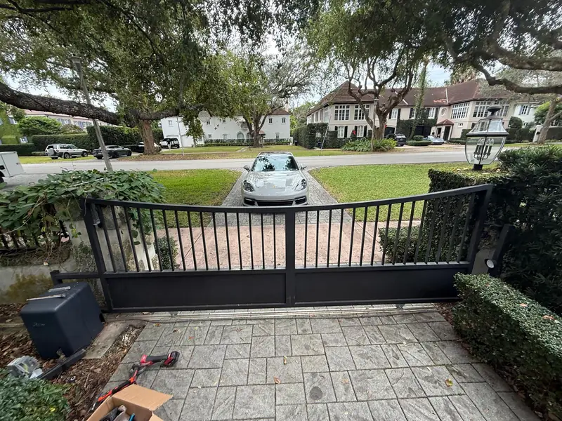 Black swing gate on a residential driveway