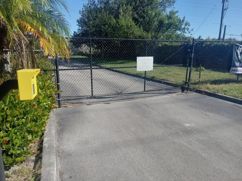 Chain link driveway gate with an operator