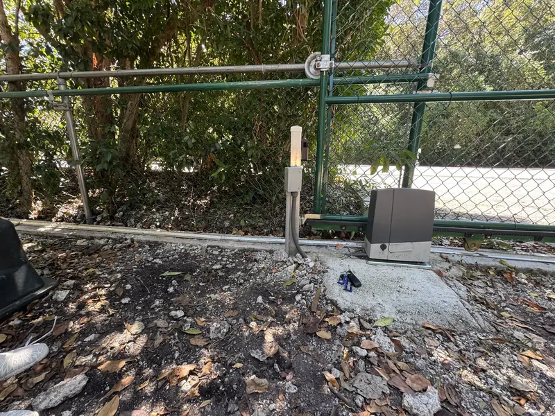 Slide gate operator on a chain link gate