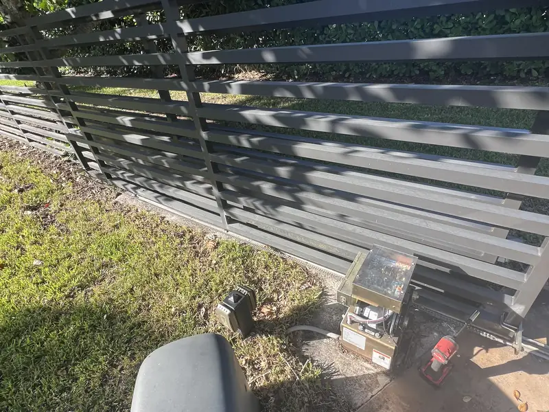 Slide gate operator on a horizontal slat gate