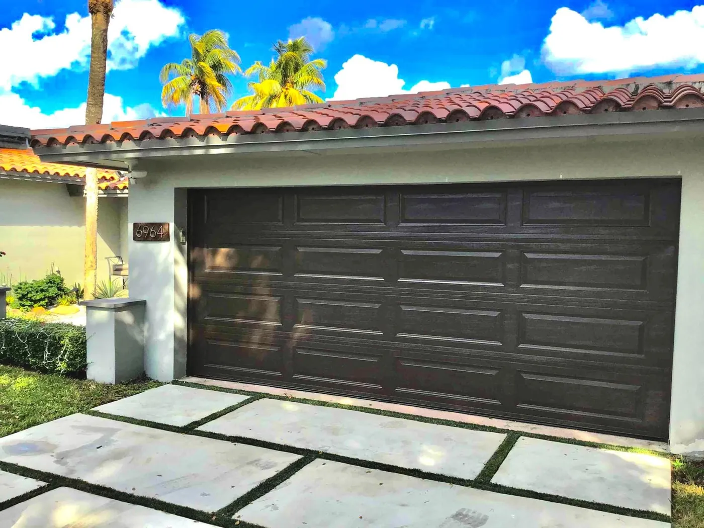 Garage door installed on a Miami home with a Spanish tile roof