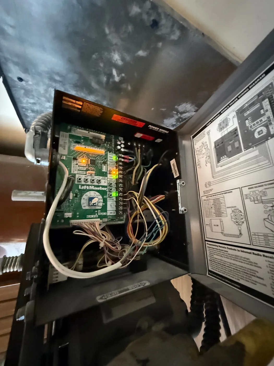 Wiring and logic board inside a garage door opener during a repair