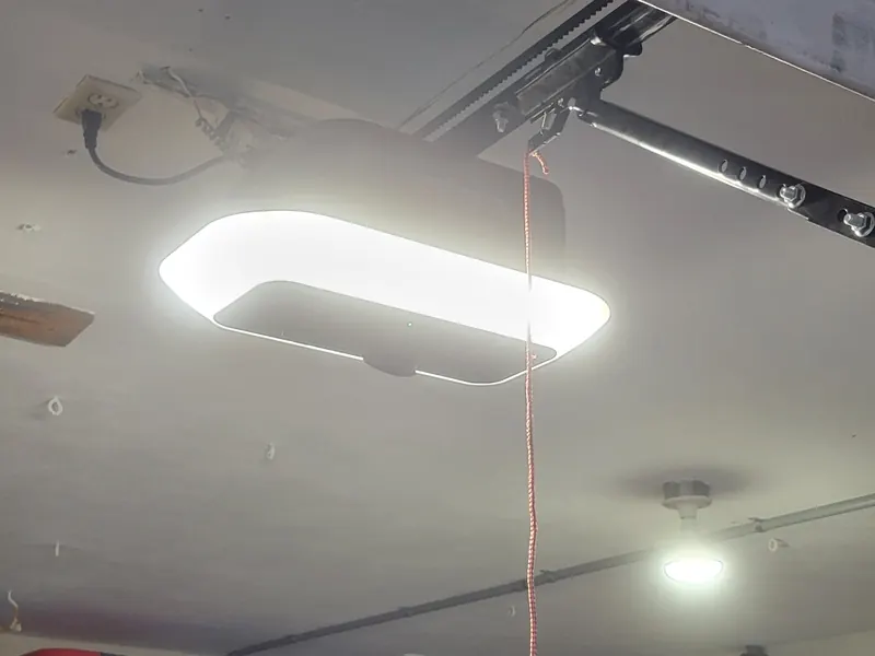 Garage door opener rail with an LED light bar