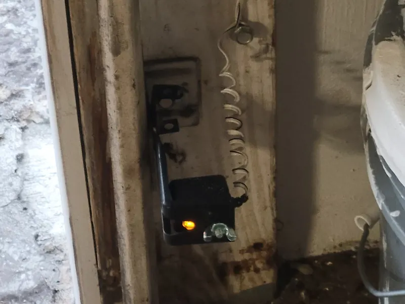 Photo eye safety sensor mounted on the garage door jamb
