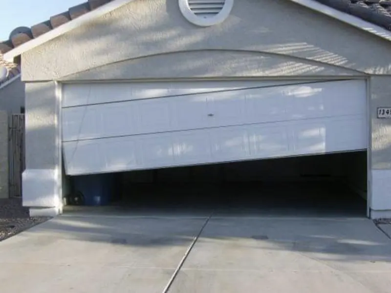 Garage door with a bent top panel before repair