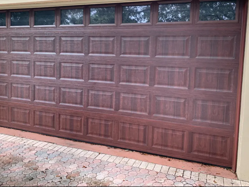 Mahogany raised panel double garage door with a window row