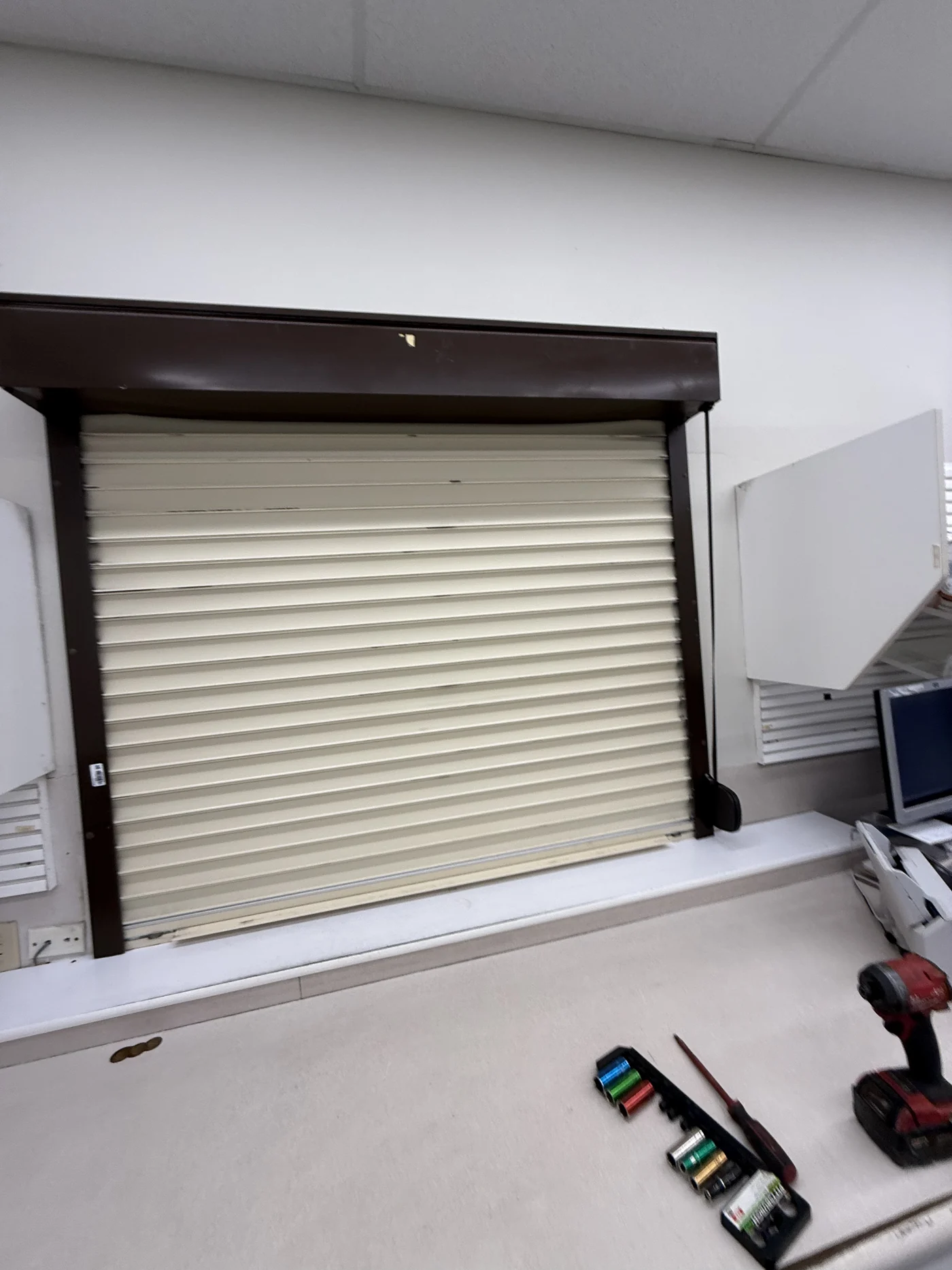Almond rolling door and hood installed above an interior opening