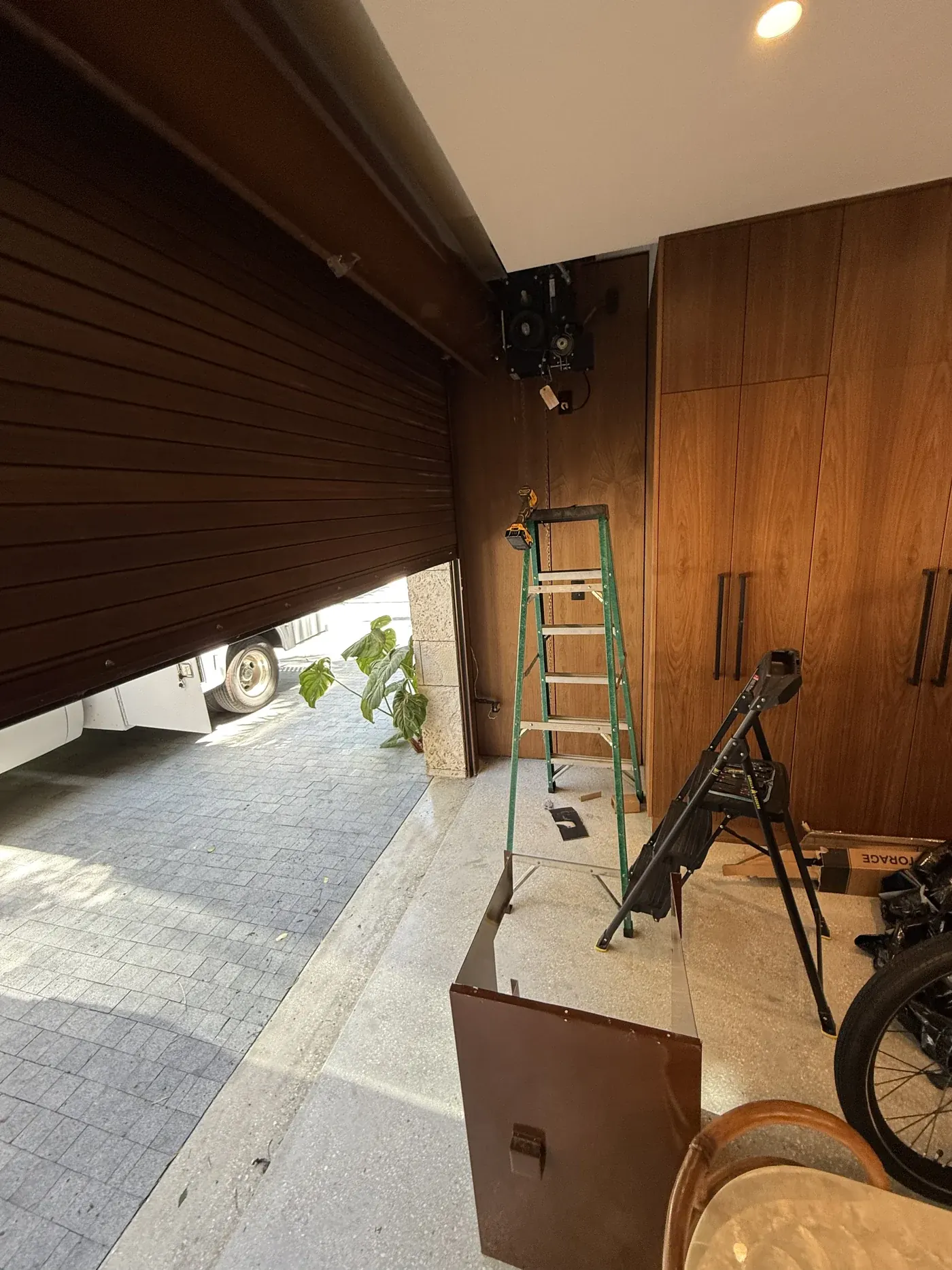 Brown rolling door raised over an interior opening after repair