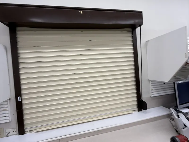 Cream rolling counter door on a service window