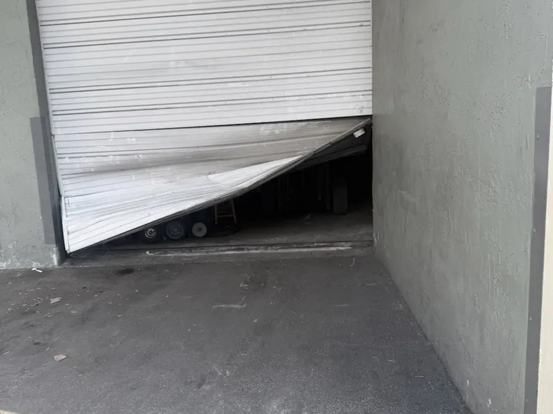 Roll up door with damaged bottom slats at a storage unit