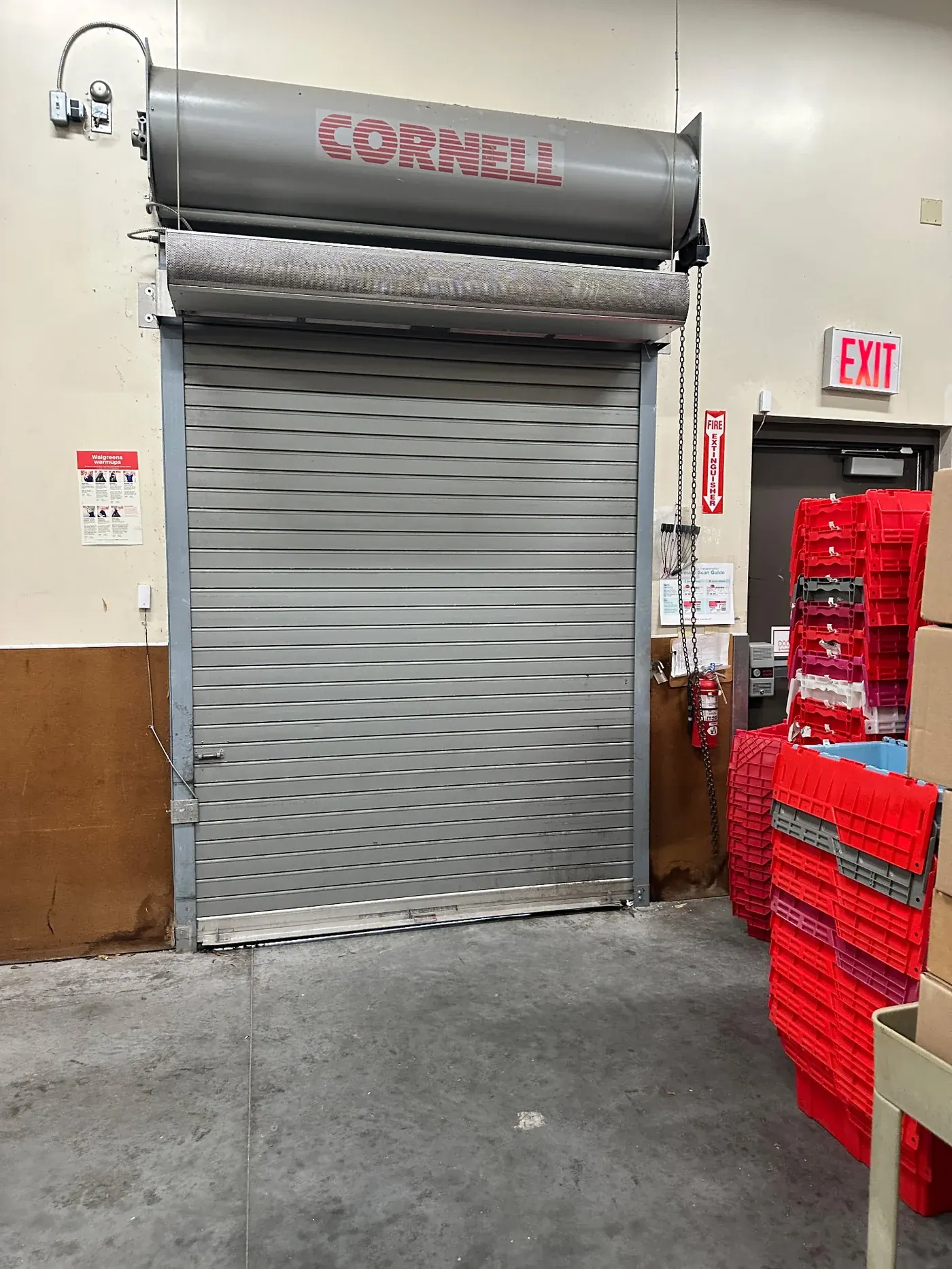 Grey rolling steel door and hood above a stockroom opening