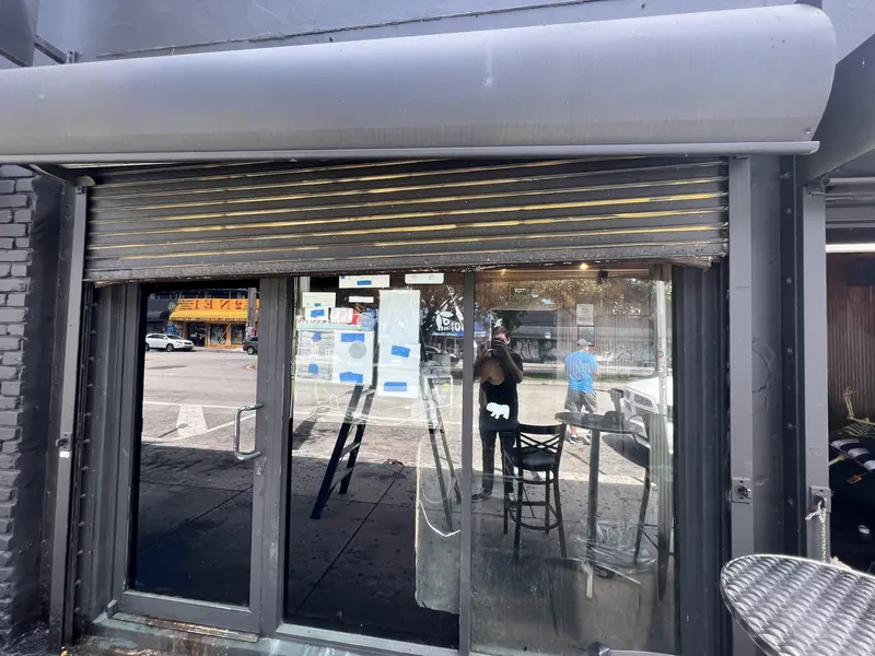 Rolling grille open above a glass storefront