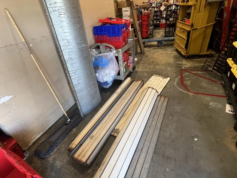New rolling door guides and slats staged for installation