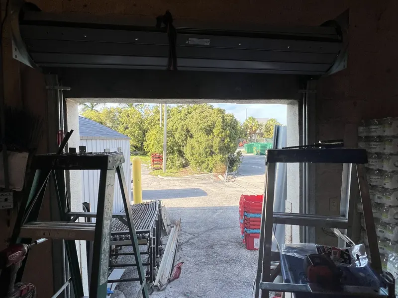 Rolling steel door open, seen from inside the bay