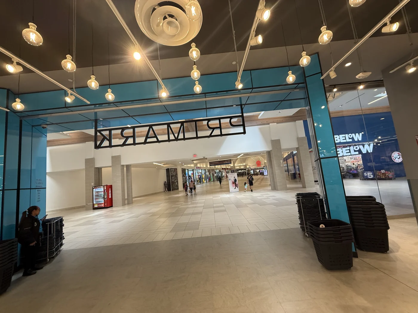 Retail mall entrance with rolling security grilles opened for trading