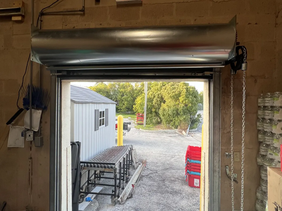 A newly fitted hood over a rolling steel door, with the curtain rolled clear of the opening