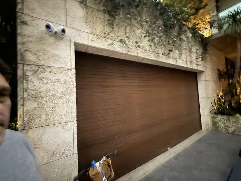 Woodgrain rolling door in a stone faced entry