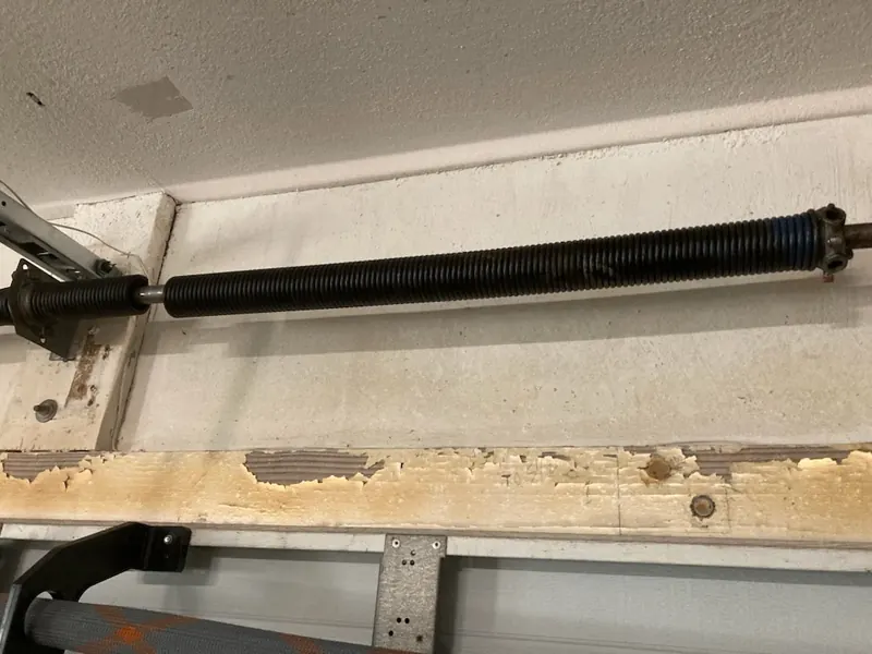 Torsion spring on the shaft above a garage door, close view