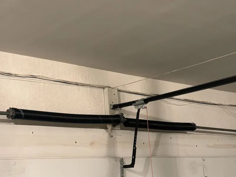 Torsion spring mounted on the shaft above a residential garage door