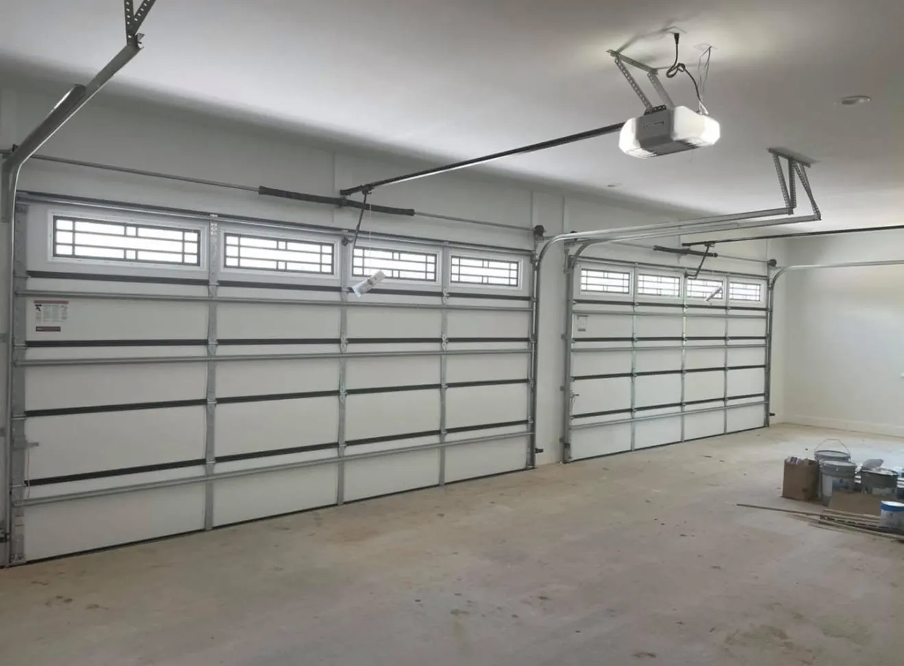 Newly installed white garage doors seen from inside