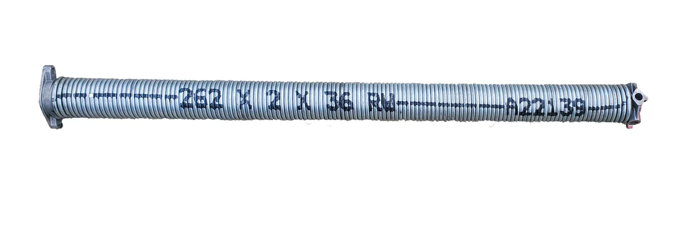 A garage door torsion spring, showing the wind stamp that gives its wire size, inside diameter and length