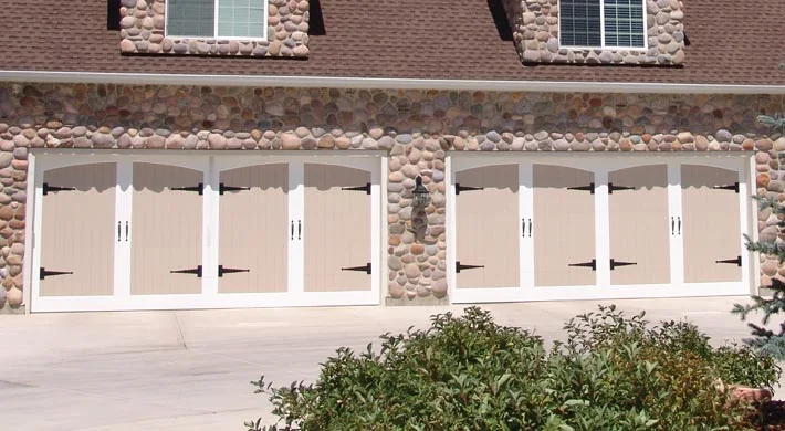 Cream cross-buck carriage doors with window inserts